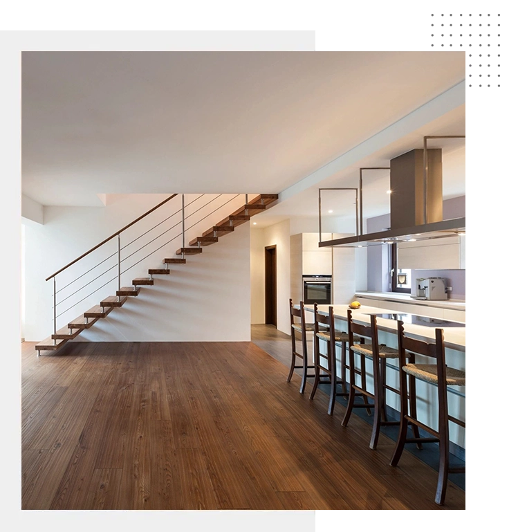 Modern open-concept kitchen and dining area with hardwood flooring, a staircase with metal railings, a kitchen island with bar stools, and minimalist decor. Financing options available.